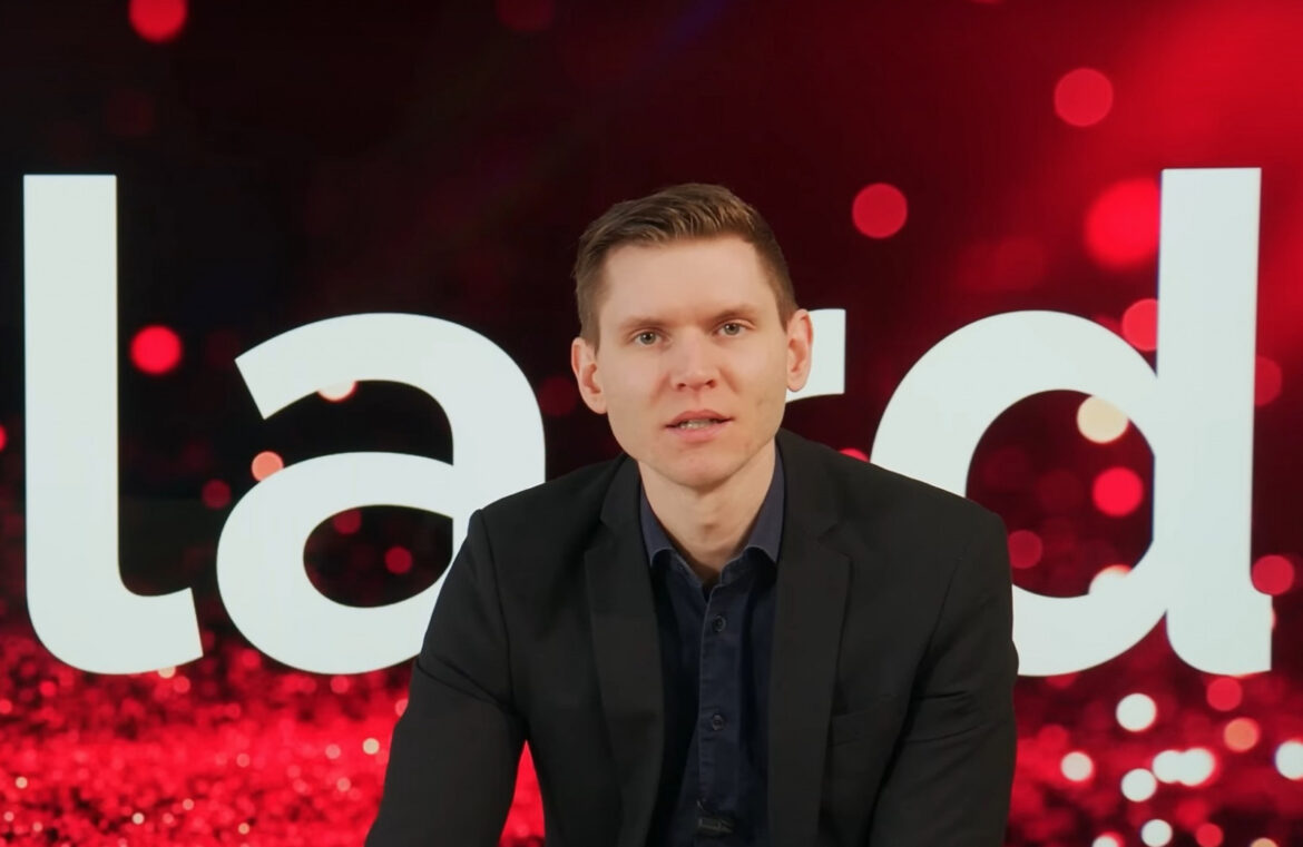 Marcus Allard i mörk kostym i en tv-studio.