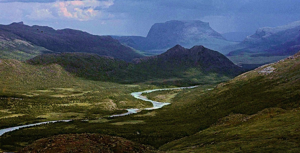 Rapadalen i Sarek med en slingrande älv och Tjakkeli i bakgrunden.